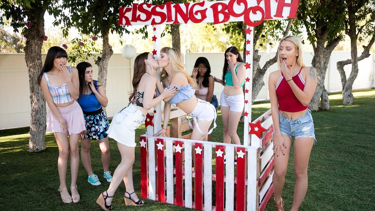 Blonde lesbian is fucking a redhead diving deep in her butthole with her tongue at the Kissing Booth