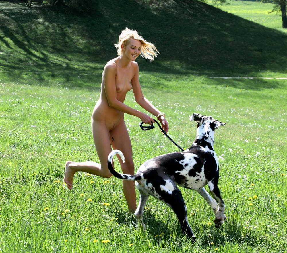Slim nude girl posing with a dog